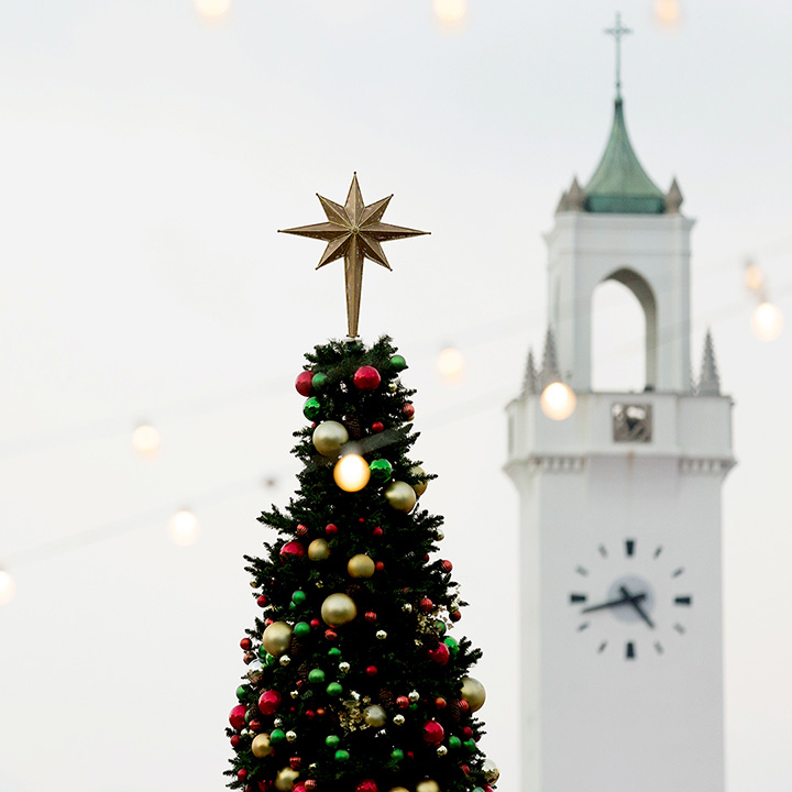 The LMU Christmas Tree in front of the Sacred Heart Chapel Clock Tower